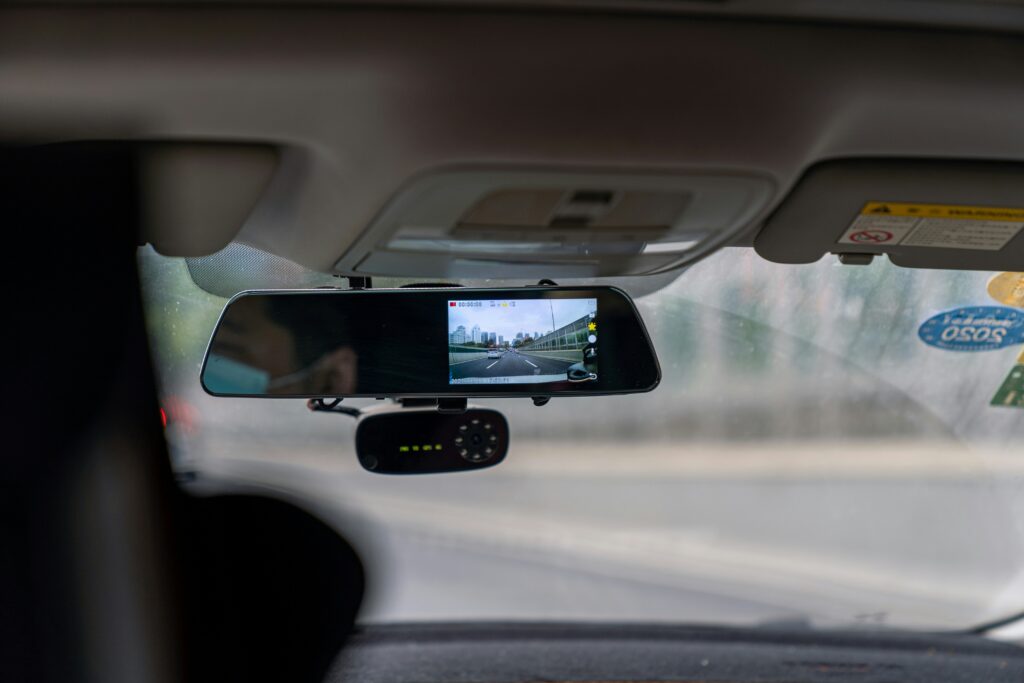A person driving a vehicle with advanced technology tracking key metrics.