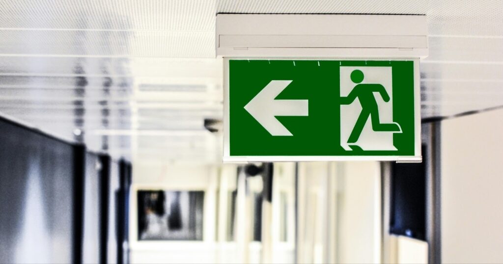 A clear fire escape sign in a health and safety compliant business establishment. 
