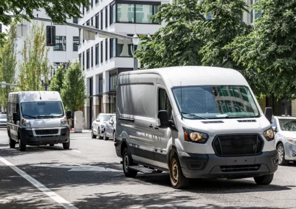 Two modern white cargo vans, showing us businesses ready for the best cargo van insurance solutions.