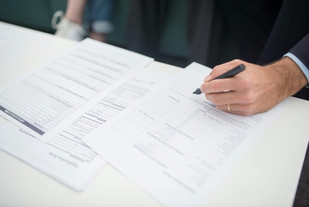 A janitorial business owner completing an insurance application form.