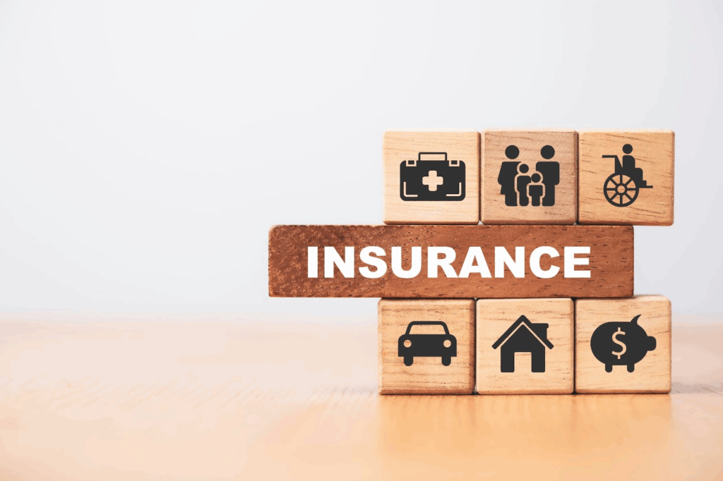 Wooden blocks with photos and the word “Insurance” in one of them.