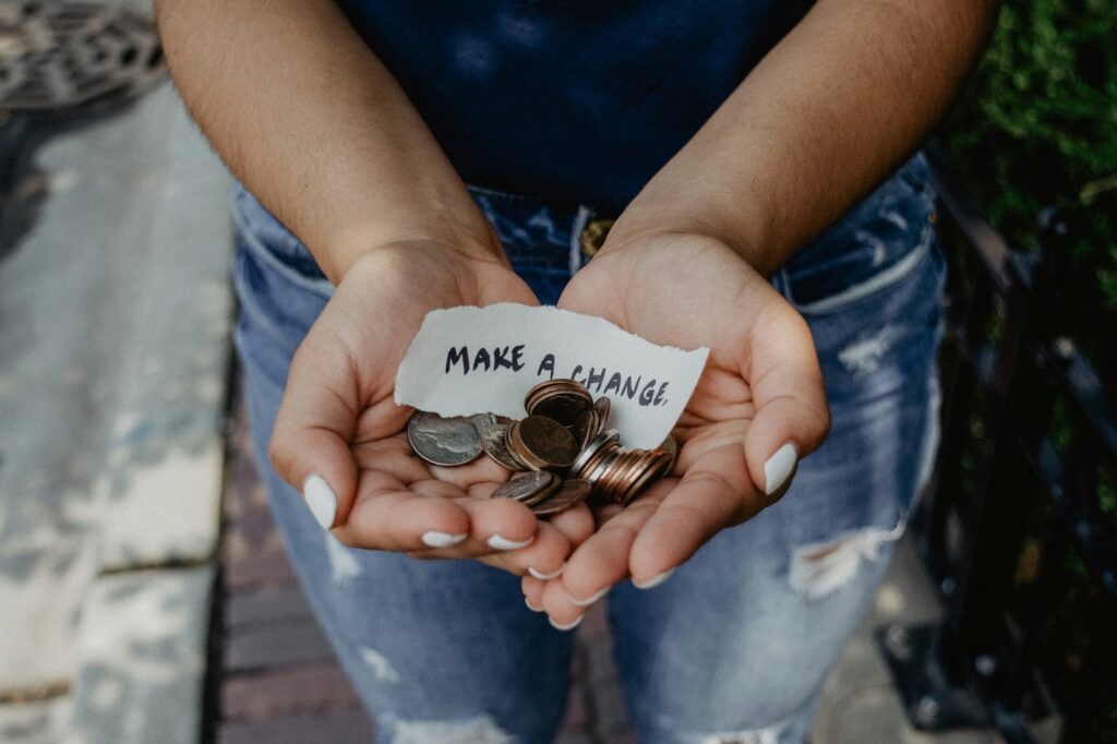 A person from a charity, collecting loose change to go toward their causes.